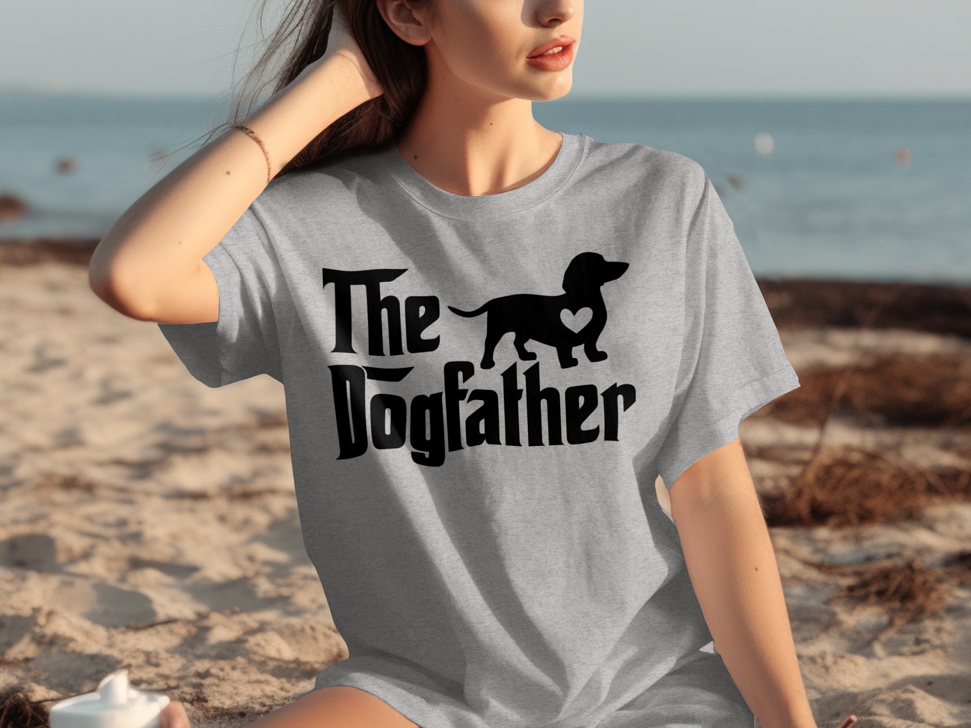 Grey t-shirt with black "The Dogfather" text and dachshund silhouette with heart.