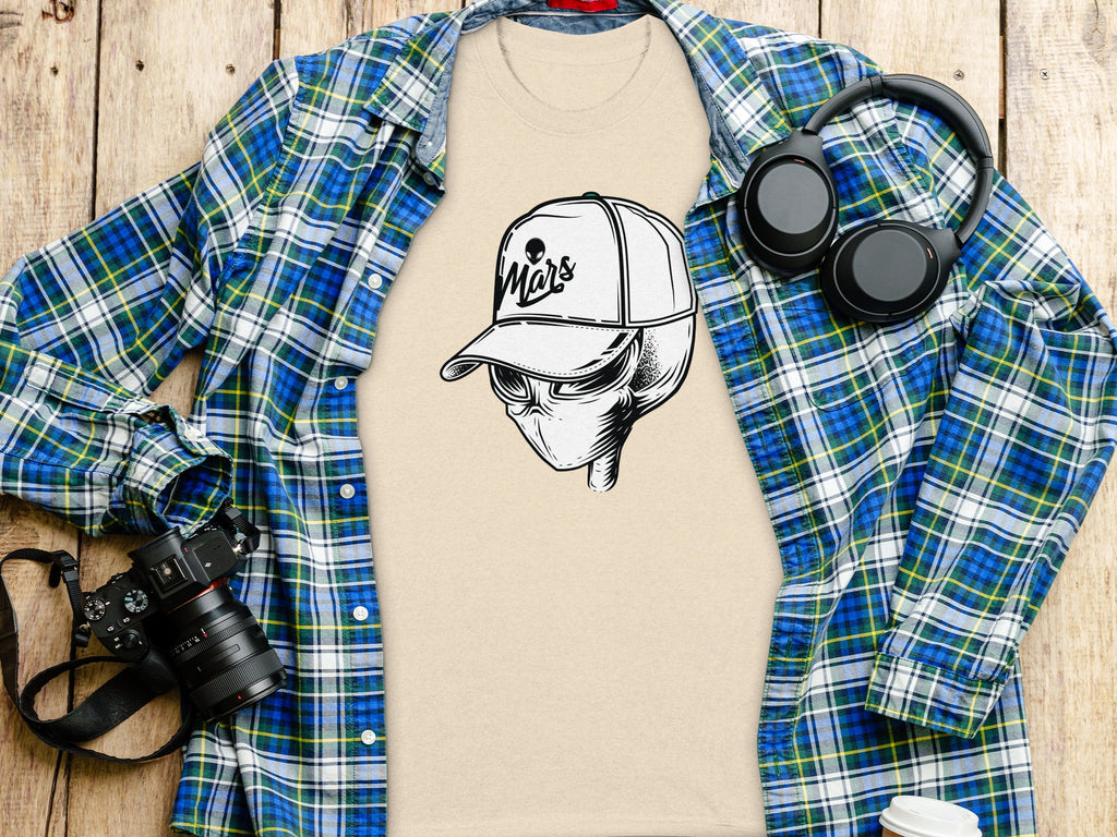 Beige t-shirt with an alien wearing a "Mars" baseball cap graphic.