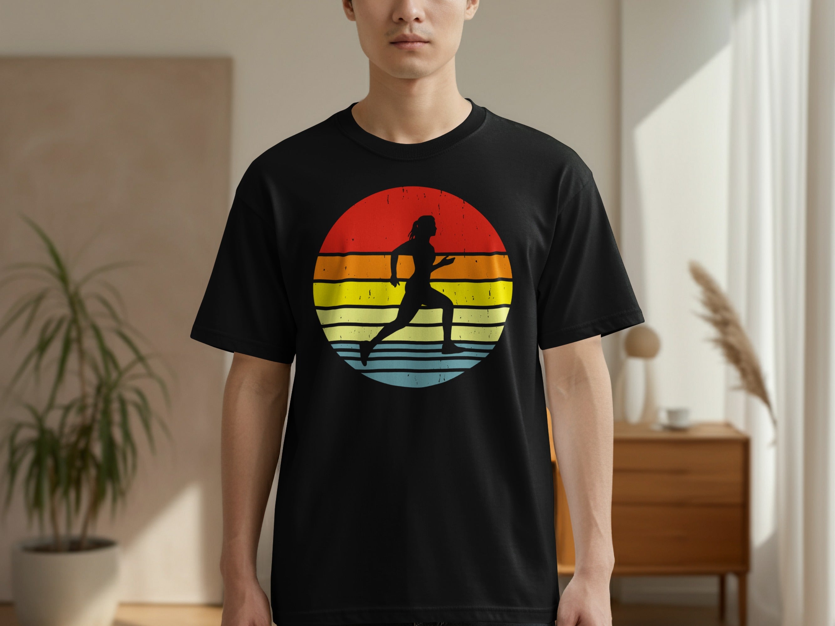 Black t-shirt with silhouette of a runner in a distressed circle of sunset colors.