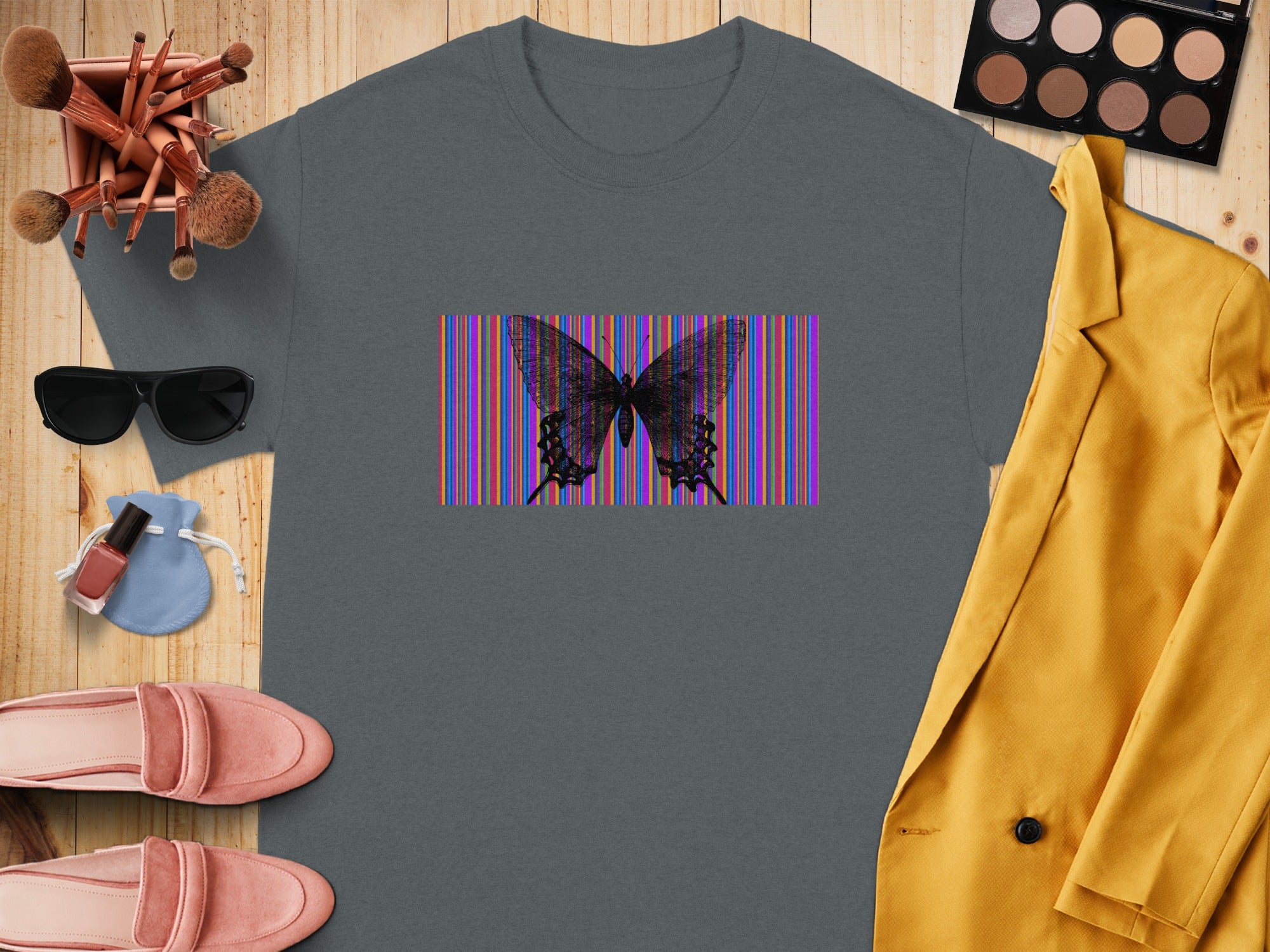 Gray t-shirt with a black butterfly over colorful vertical stripes.