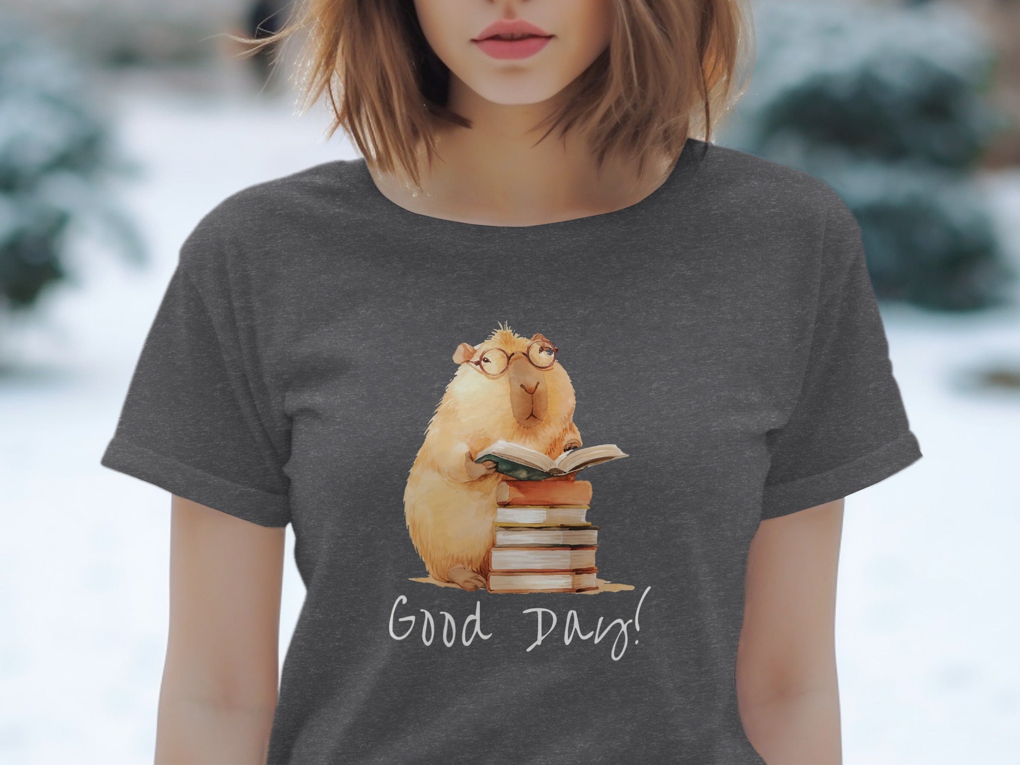 Watercolor capybara wearing glasses, reading on a stack of books, with "Good Day!" text.