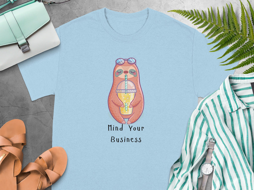 Light blue t-shirt with a cartoon sloth, sunglasses, and lemonade text "Mind Your Business".