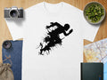 White t-shirt with black graphic silhouette of a runner abstractly rendered with paint splatters.