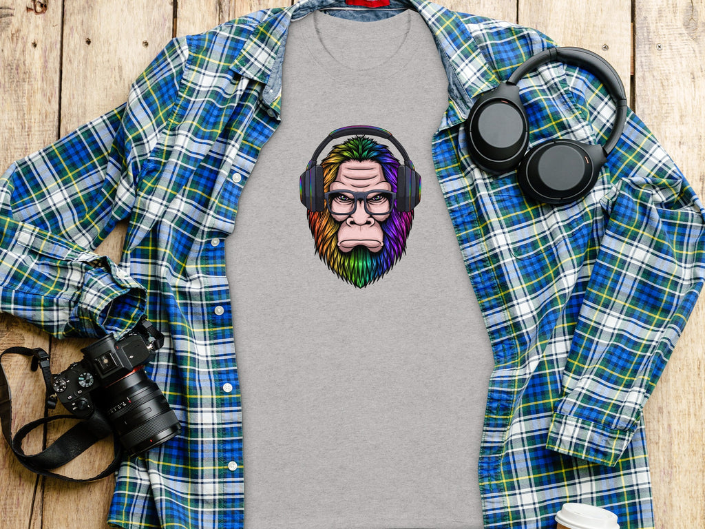 Grey t-shirt with rainbow Bigfoot wearing glasses and headphones graphic.