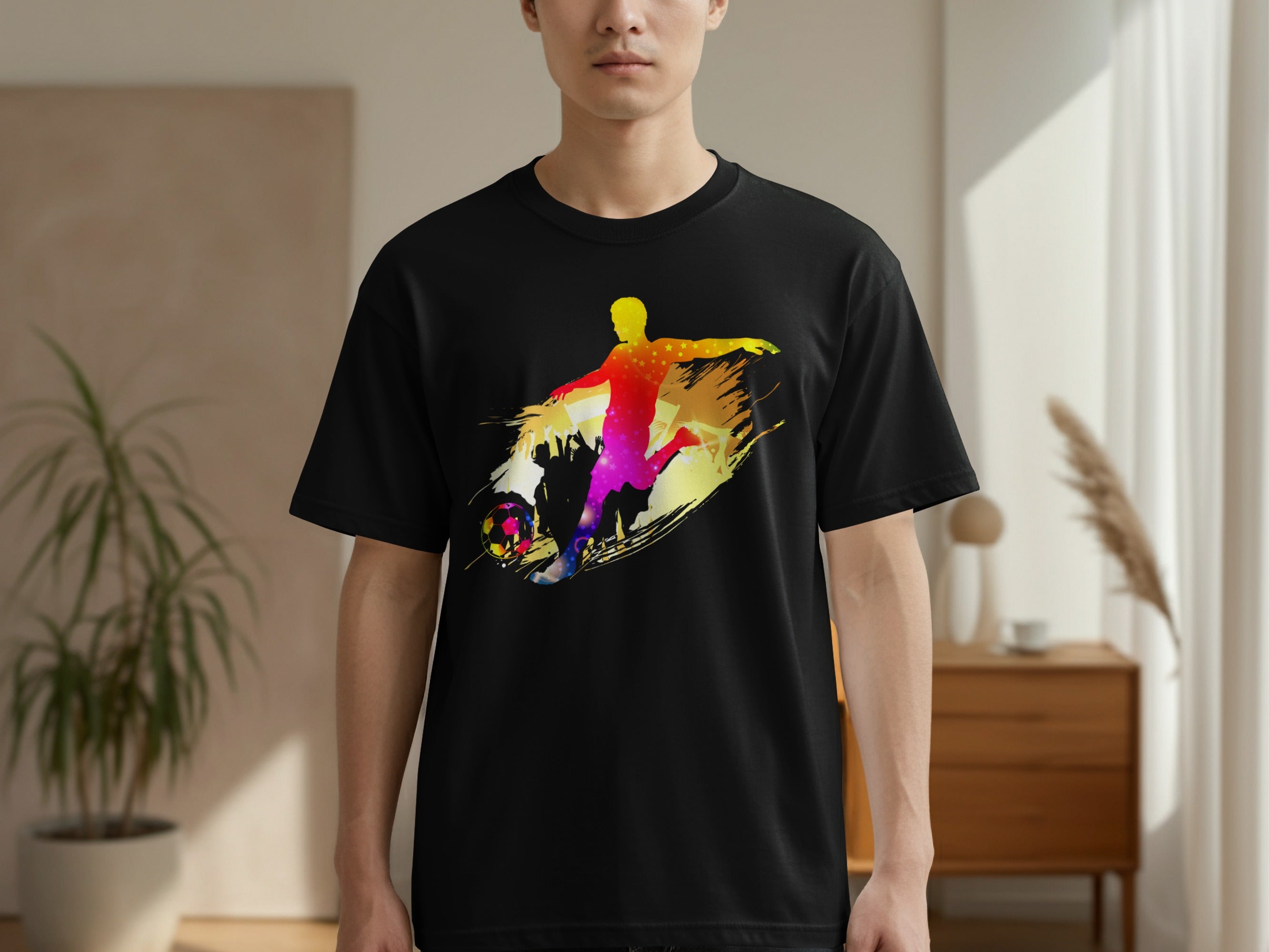 Black t-shirt with a colorful graphic of a soccer player kicking a ball.