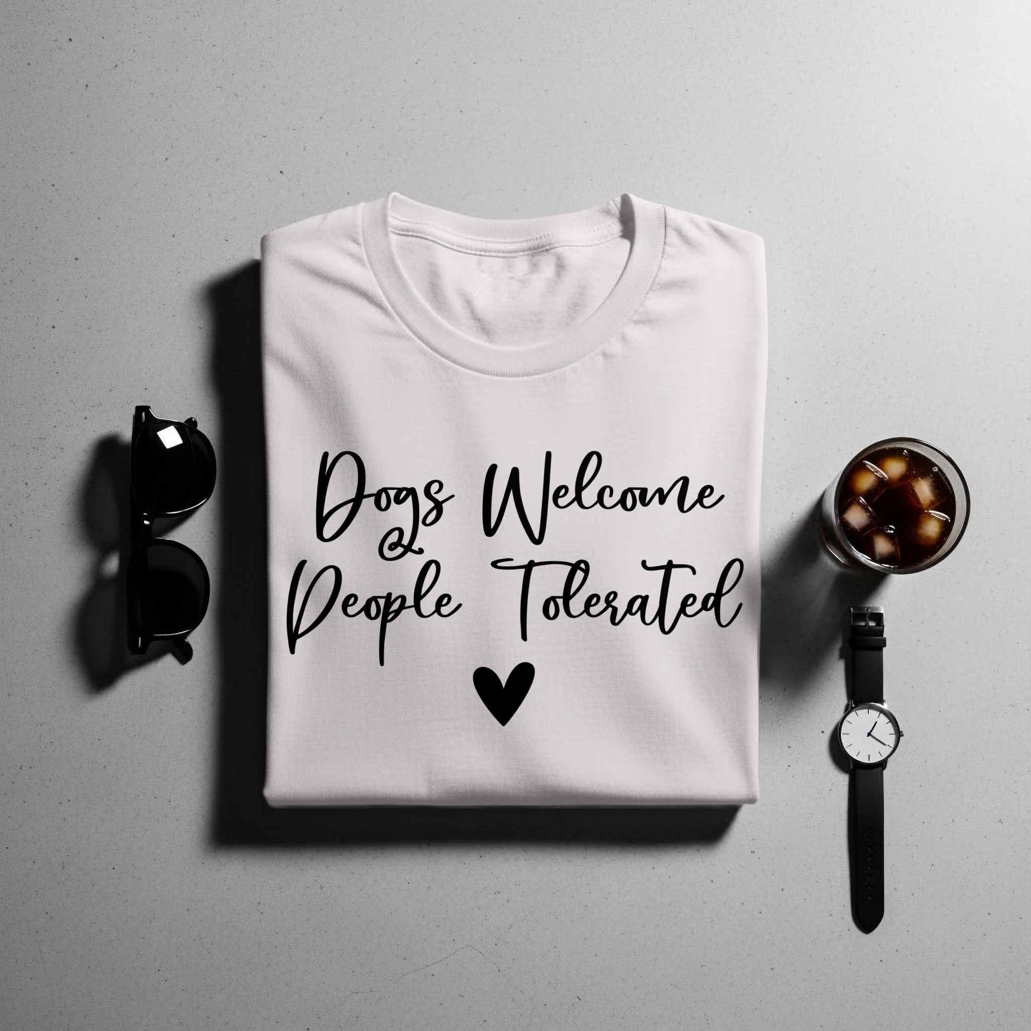 White t-shirt with black text "Dogs Welcome People Tolerated" and a heart.