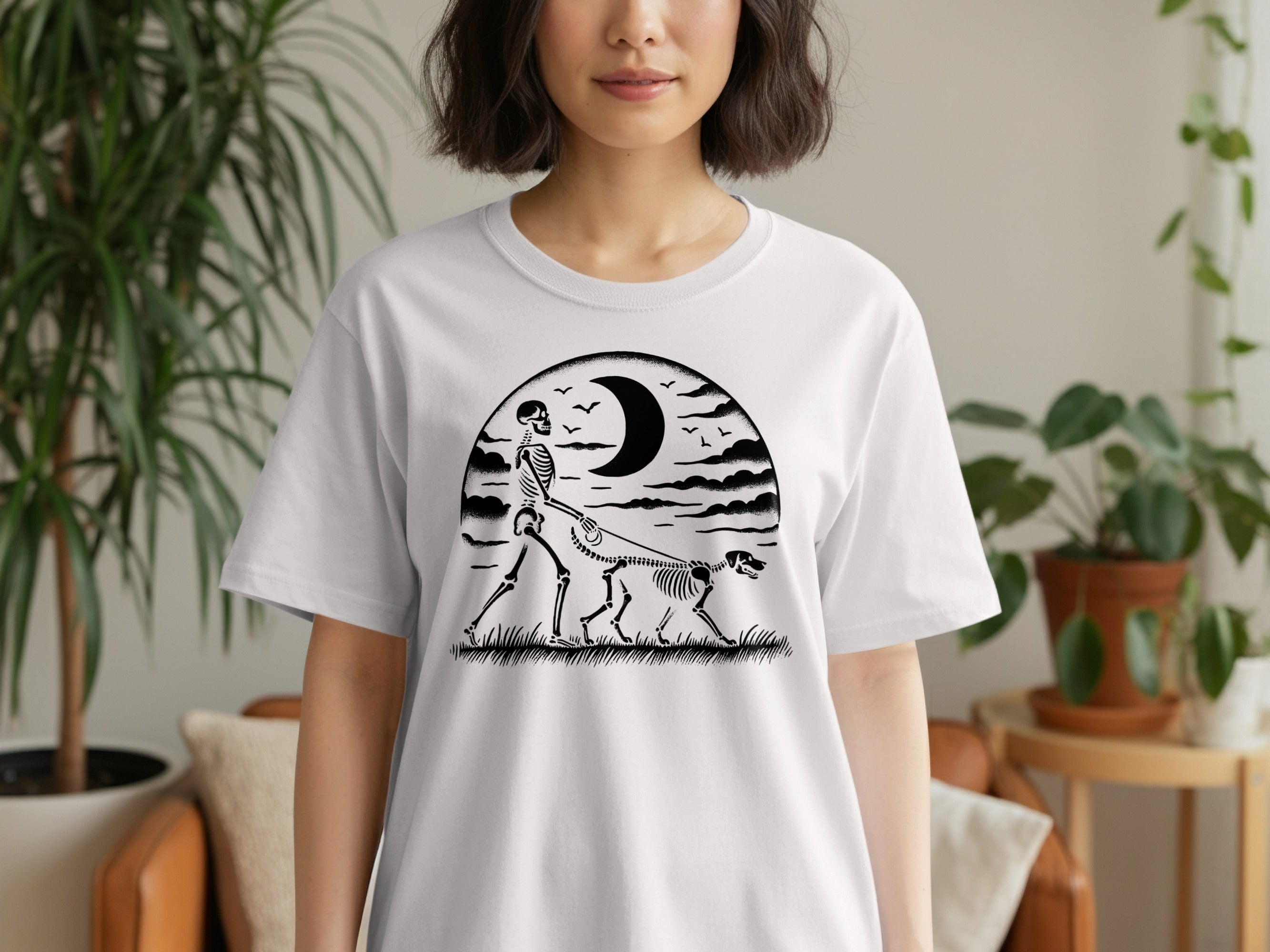 Skeleton walking a dog under a crescent moon and clouds.