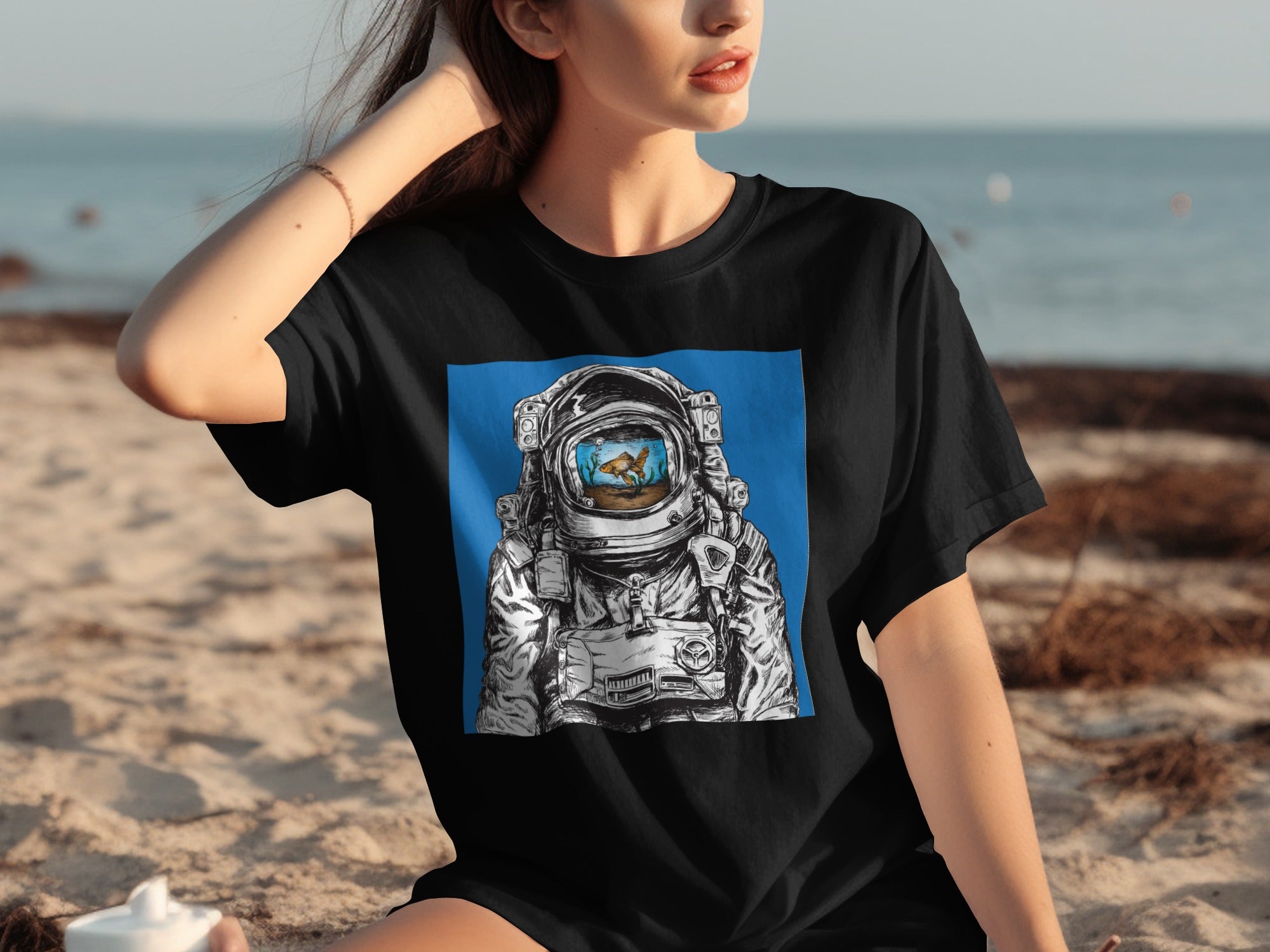 Black t-shirt with astronaut helmet graphic containing a goldfish in a fishbowl.
