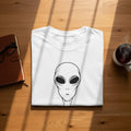 White t-shirt with a black outline drawing of an alien's head.