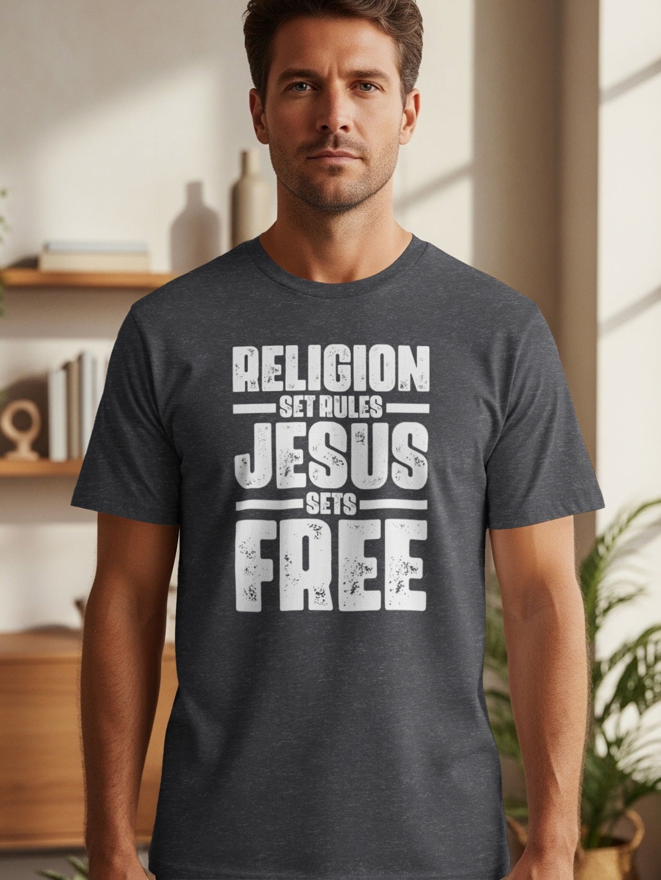 Dark grey t-shirt with white text "RELIGION SET RULES JESUS SETS FREE".