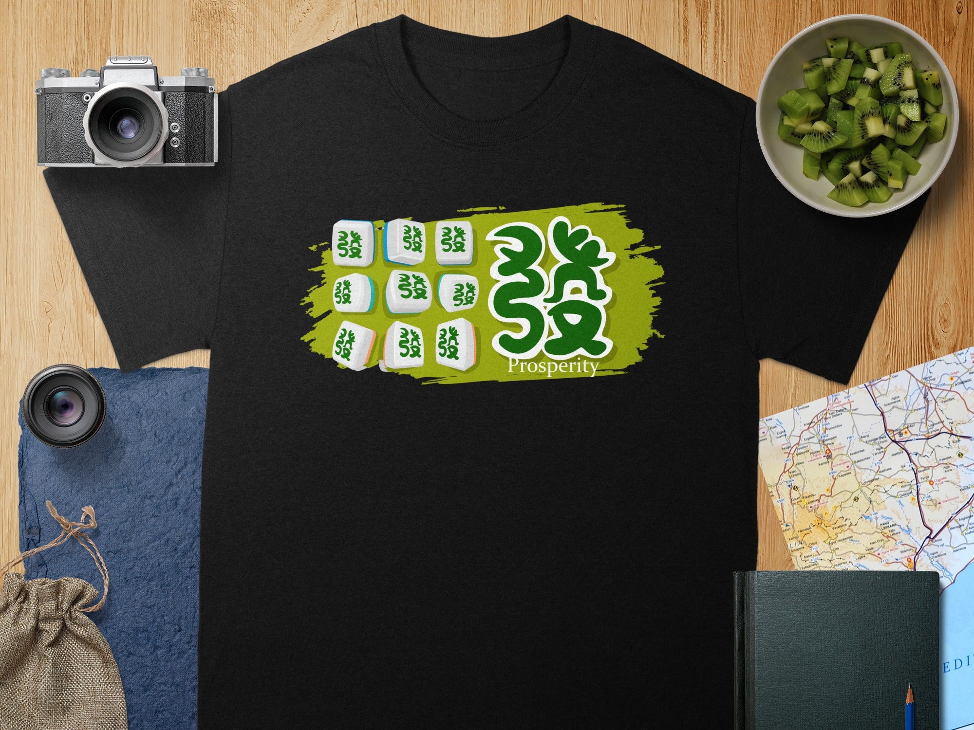 Black t-shirt with Mahjong tiles and "Prosperity" text on a green brush stroke design.