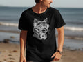 Black t-shirt with a white line drawing of a cat wearing goggles and a bowtie.