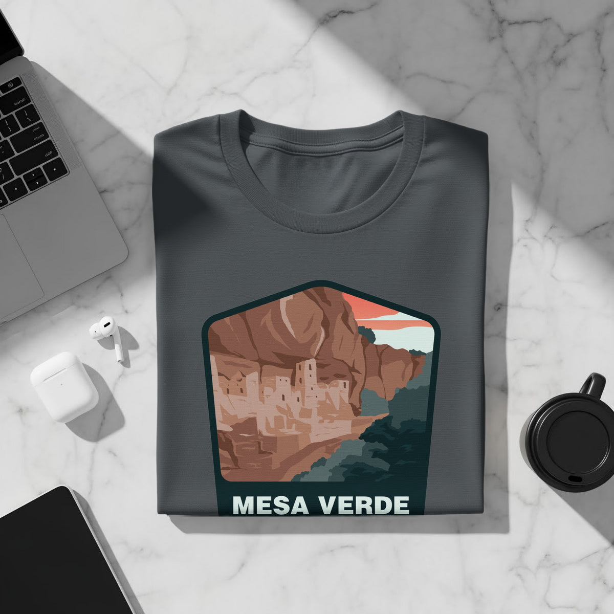 T-shirt featuring Mesa Verde cliff dwellings artwork.