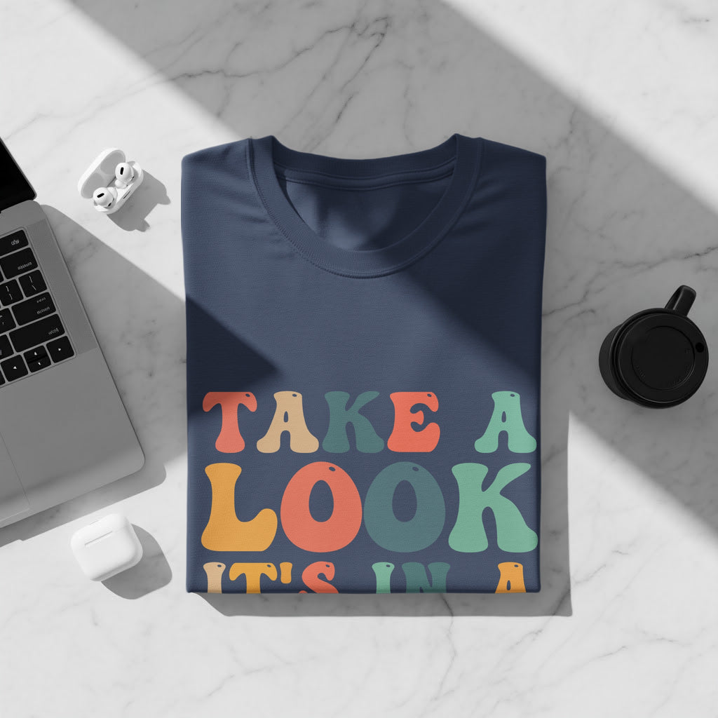 Navy blue t-shirt with colorful "TAKE A LOOK IT'S IN A" text.