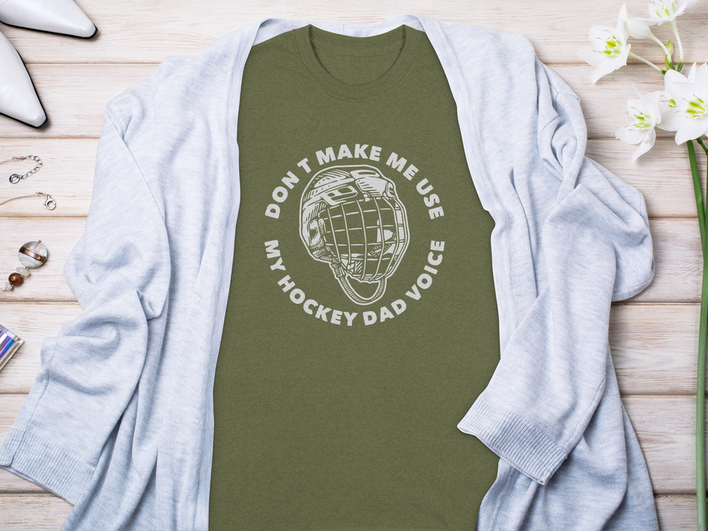 Olive green t-shirt with white text and hockey helmet graphic.