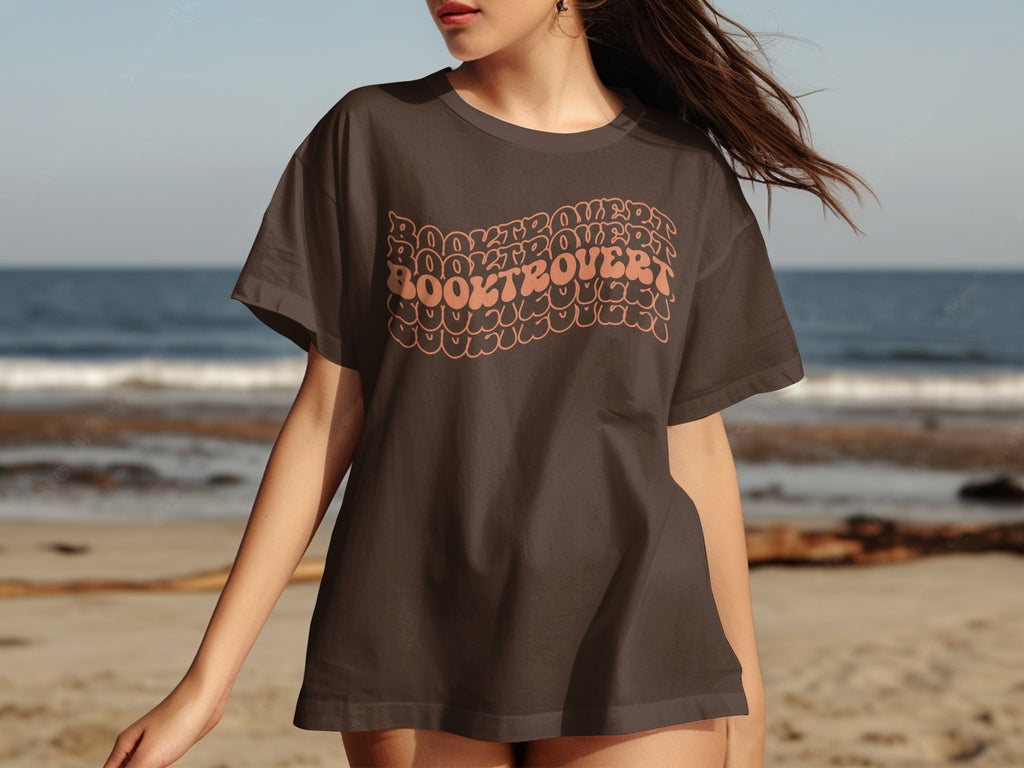 Brown t-shirt with repeating "Booktrovert" text graphic in a retro style.