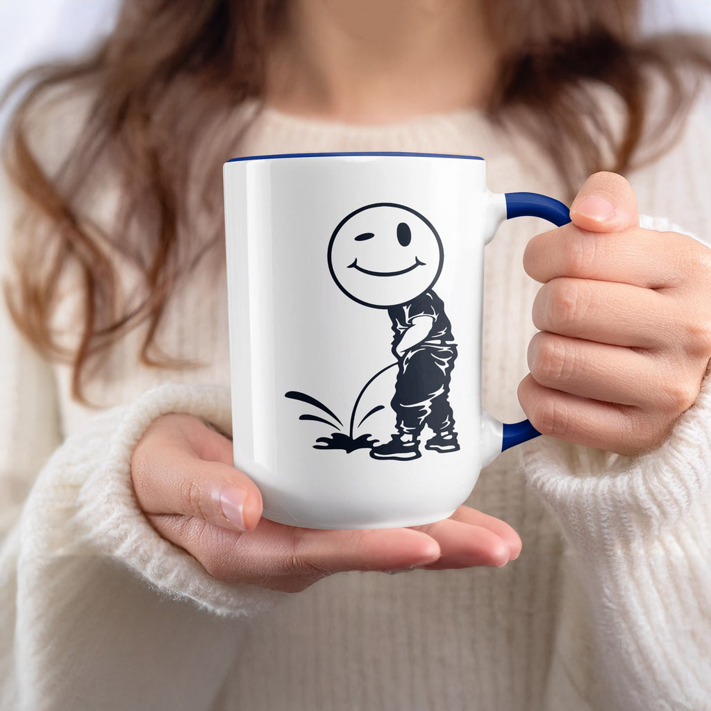 White mug with blue trim featuring a black line drawing of a winking smiley face character urinating.