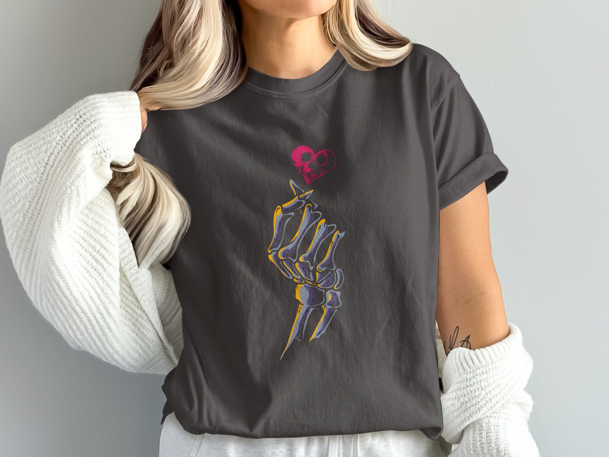Dark grey t-shirt with skeleton hand making heart shape and skull graphic.