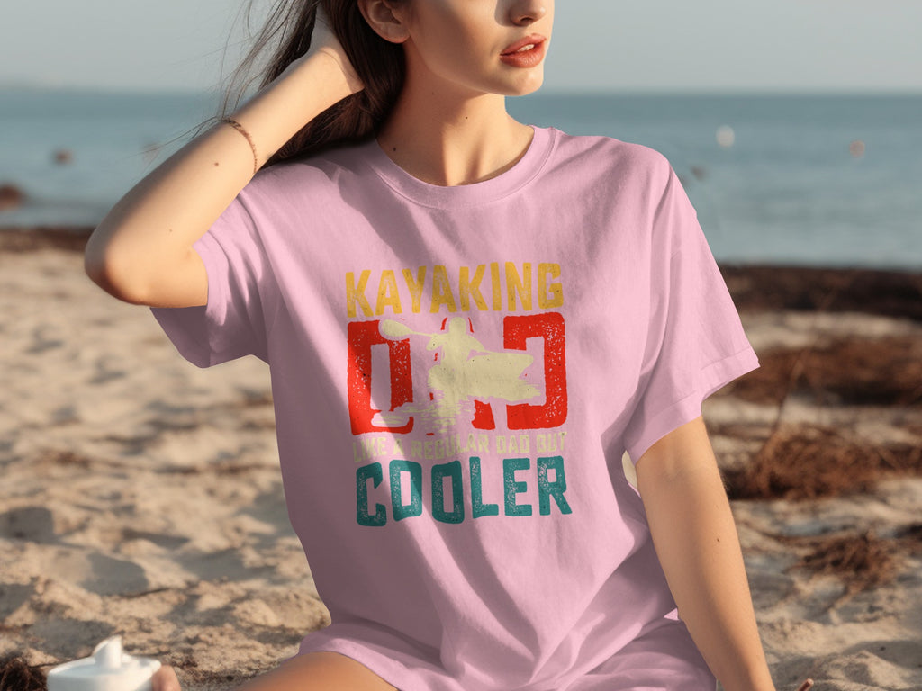 Pink t-shirt with "Kayaking Dad Like a Regular Dad But Cooler" graphic.