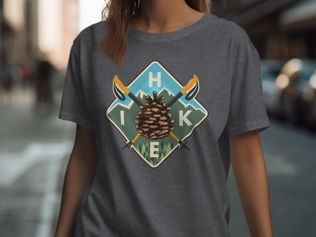 Dark grey t-shirt with a square badge featuring a pine cone, mountains, and hiking poles.