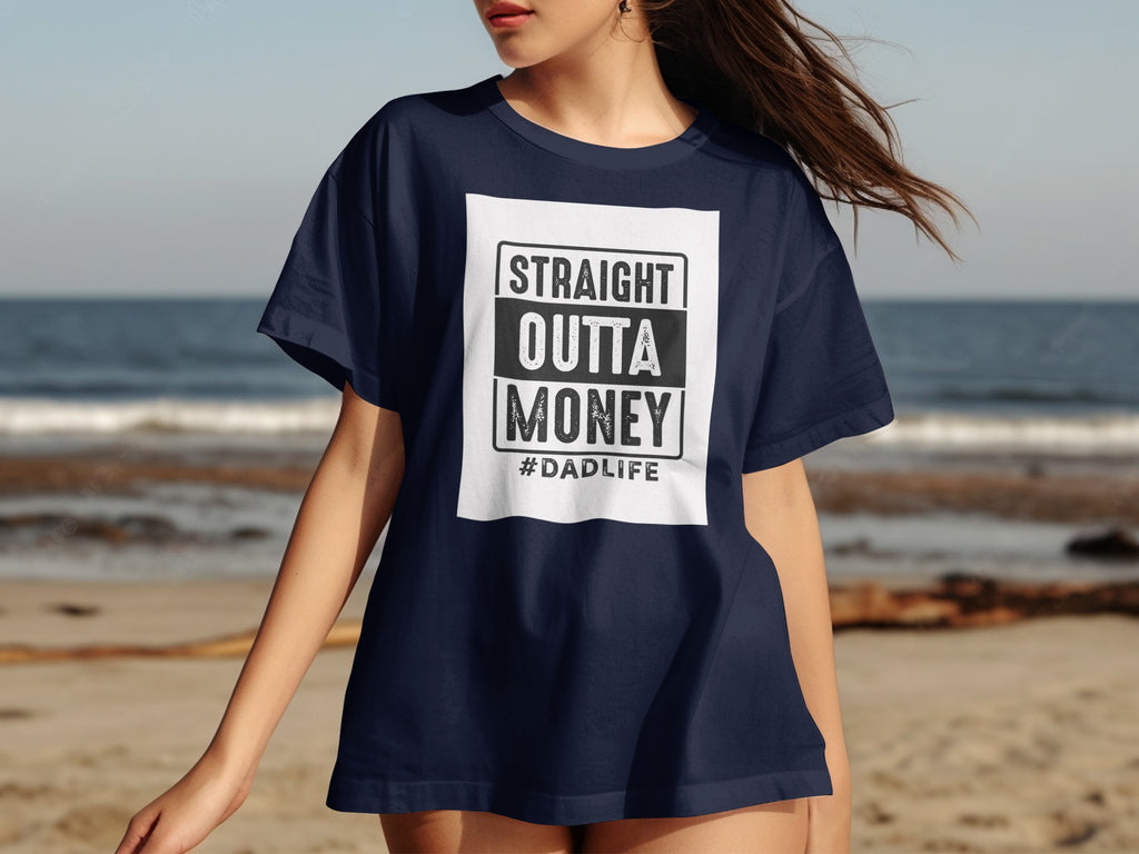 Navy t-shirt with box graphic "STRAIGHT OUTTA MONEY #DADLIFE" centered on chest.