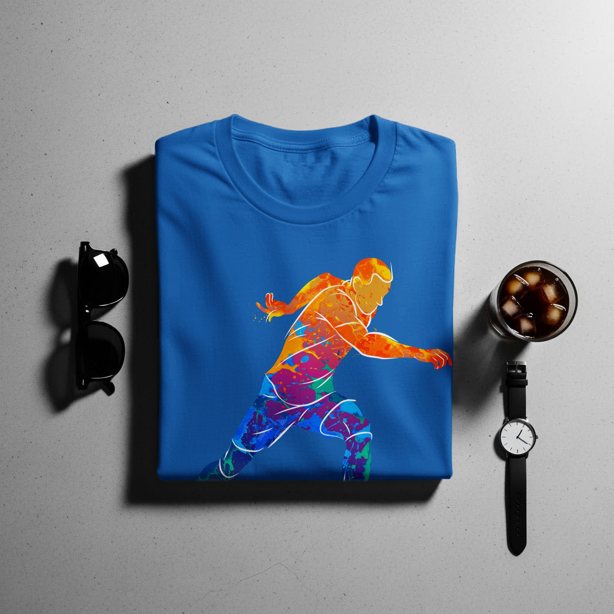 Blue t-shirt with abstract colorful runner graphic, sunglasses, watch, and drink.