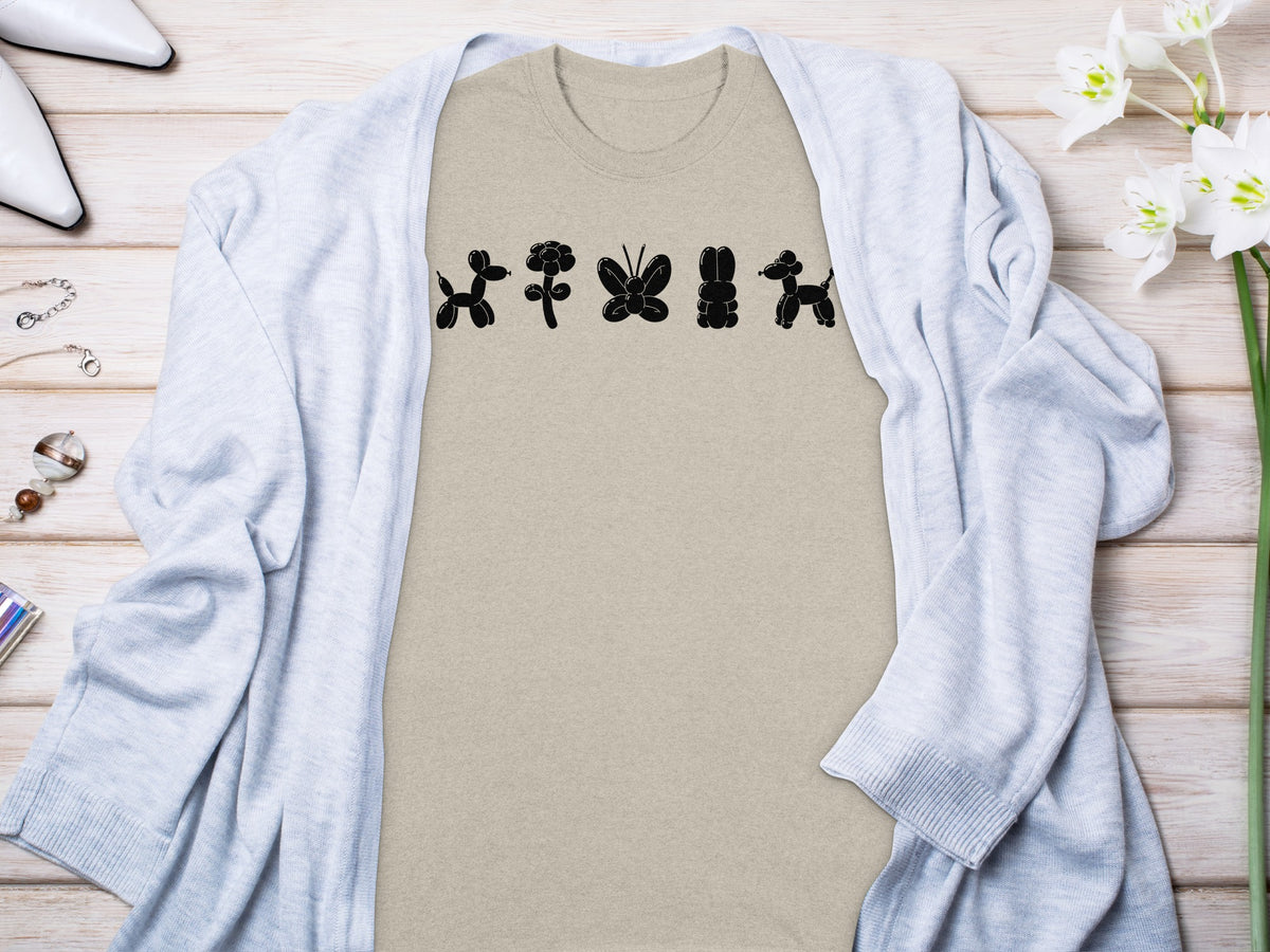 Tan t-shirt with black balloon animals: dog, flower, butterfly, rabbit, dog.