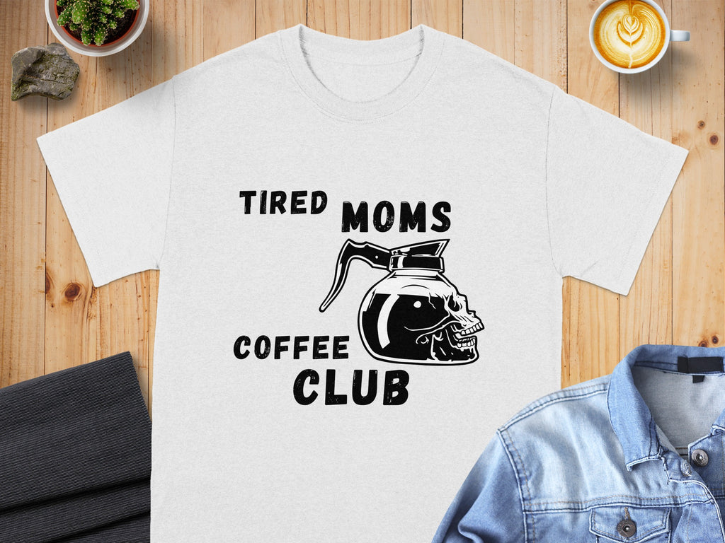 White t-shirt with black text and skull coffee pot graphic reading: Tired Moms Coffee Club.