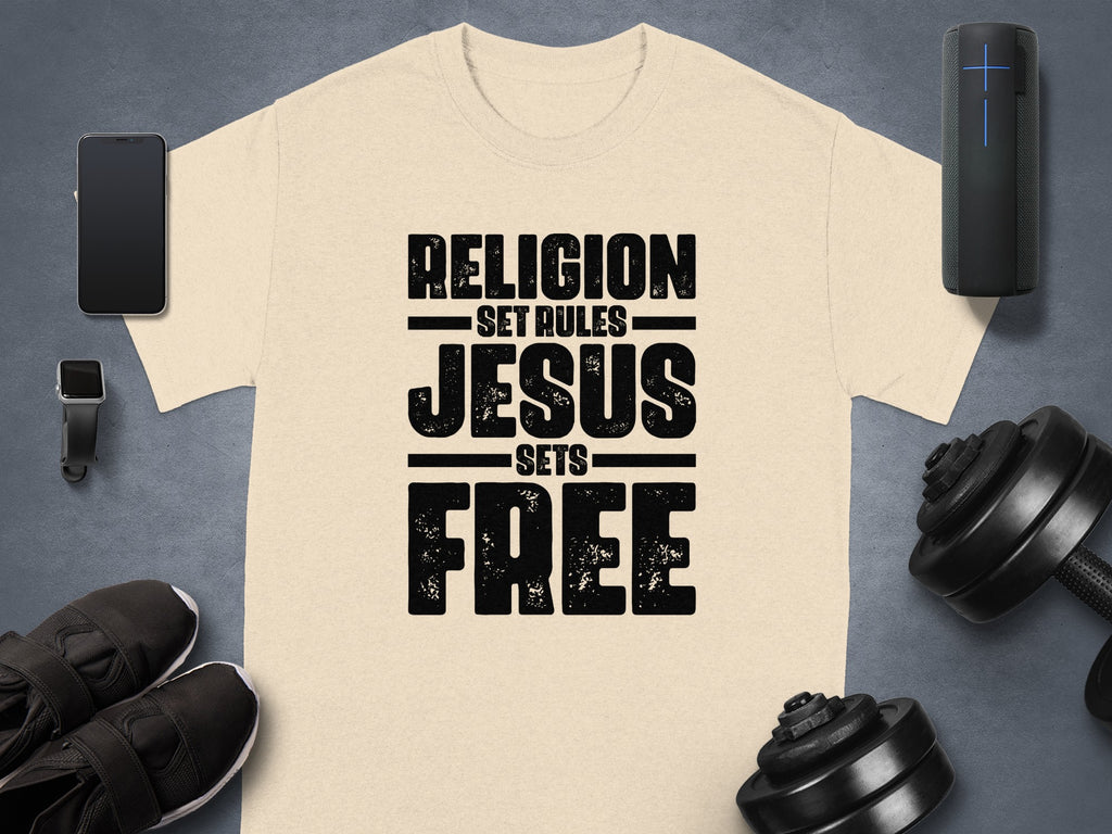 Light beige t-shirt with black distressed text reading "RELIGION SET RULES JESUS SETS FREE".