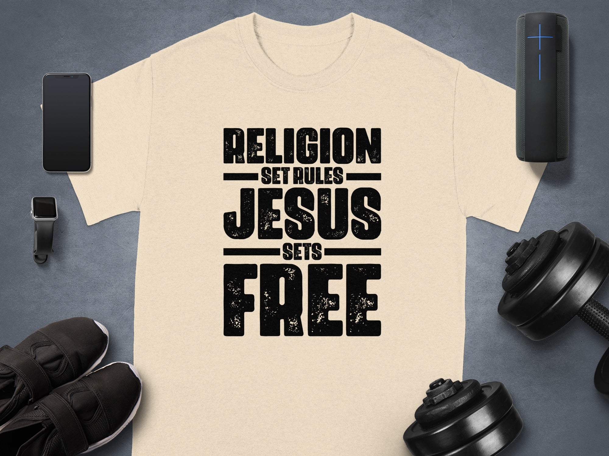 Light beige t-shirt with black distressed text reading "RELIGION SET RULES JESUS SETS FREE".