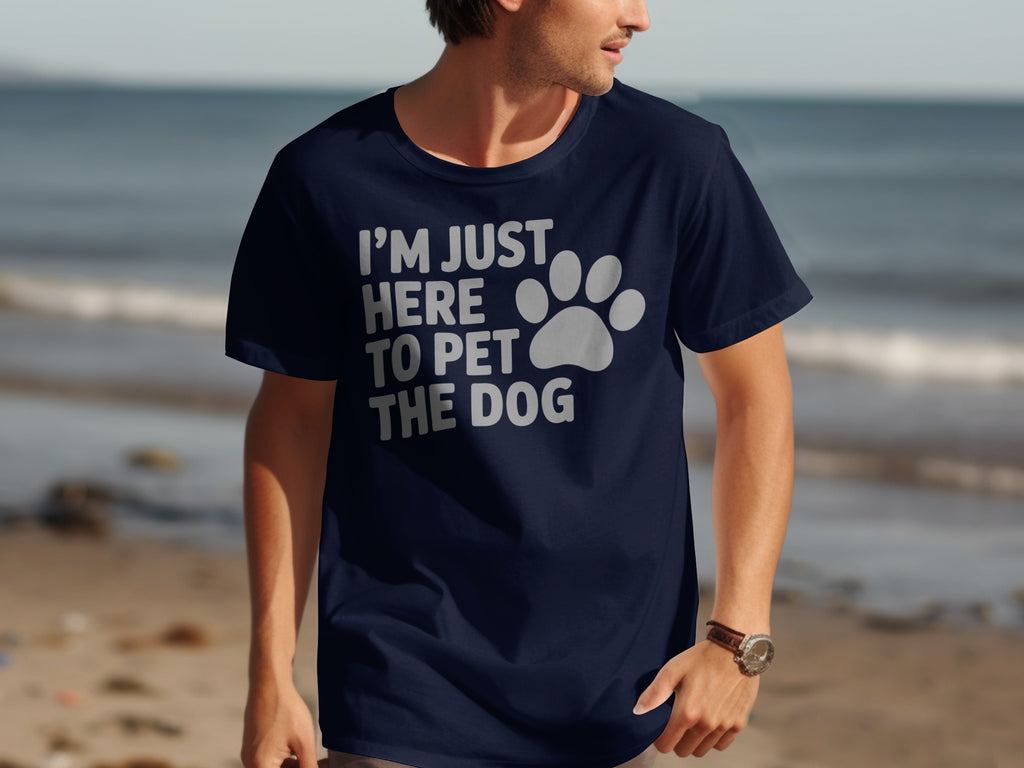 Navy t-shirt with white text "I'M JUST HERE TO PET THE DOG" and a paw print.