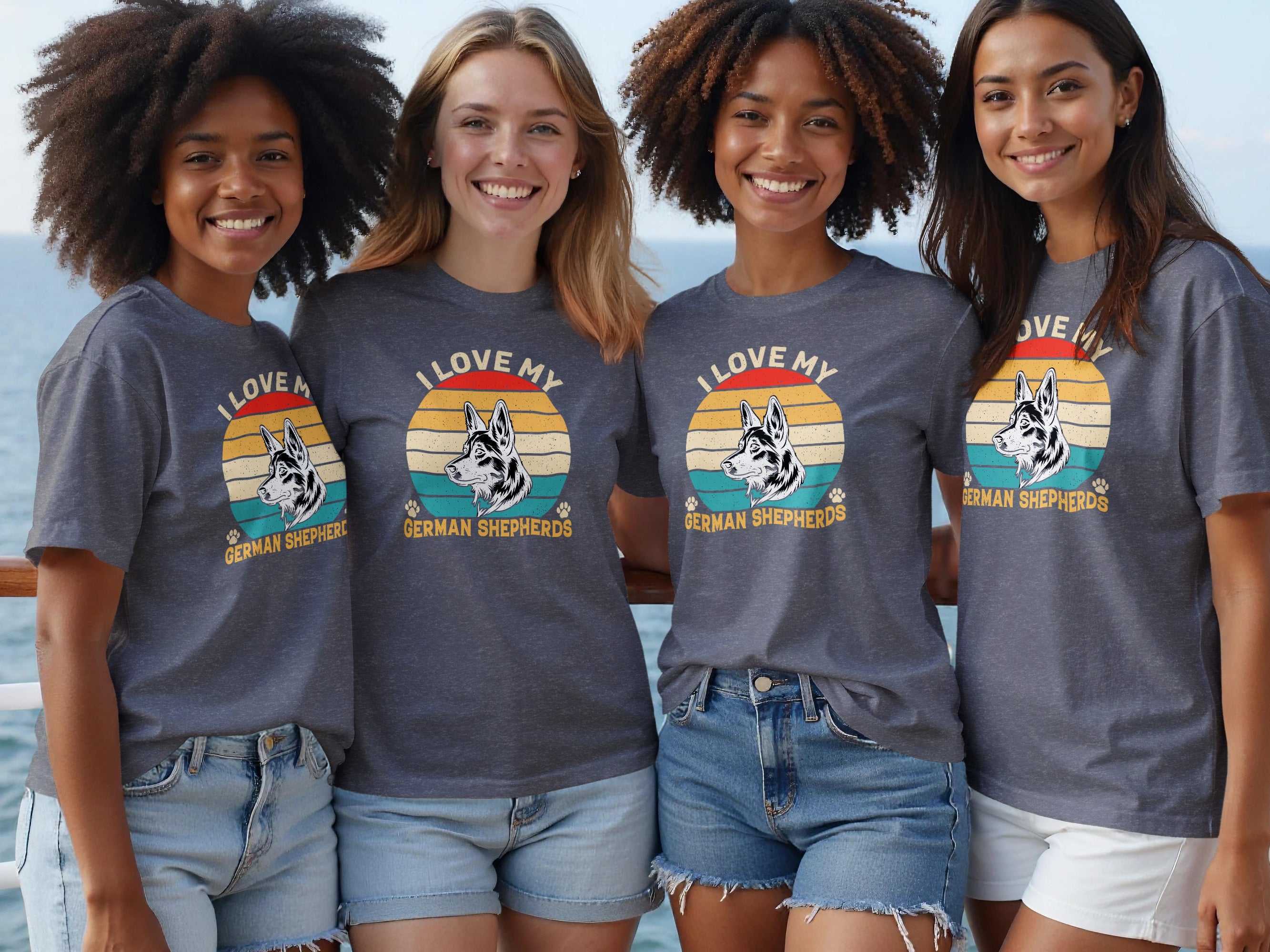 Four women wear dark grey t-shirts with a graphic of a German Shepherd against a retro sun and text.