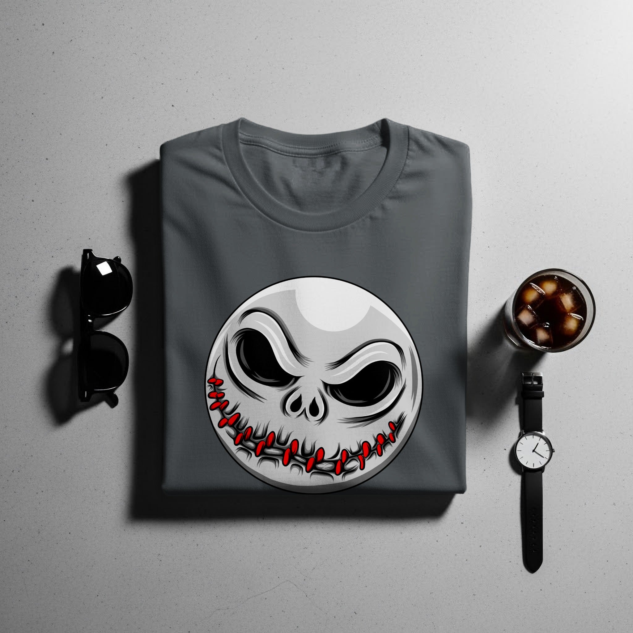 Dark grey t-shirt with stitched smiley face graphic, sunglasses, watch, and drink.