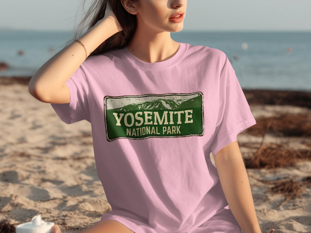 Pink t-shirt with "Yosemite National Park" text and mountain graphic.