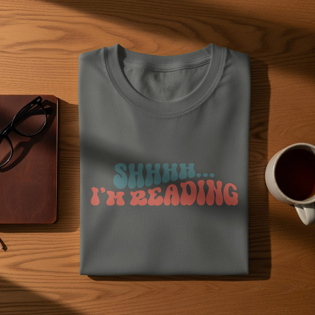 Gray t-shirt with "SHHHH... I'M READING" in retro wavy text.