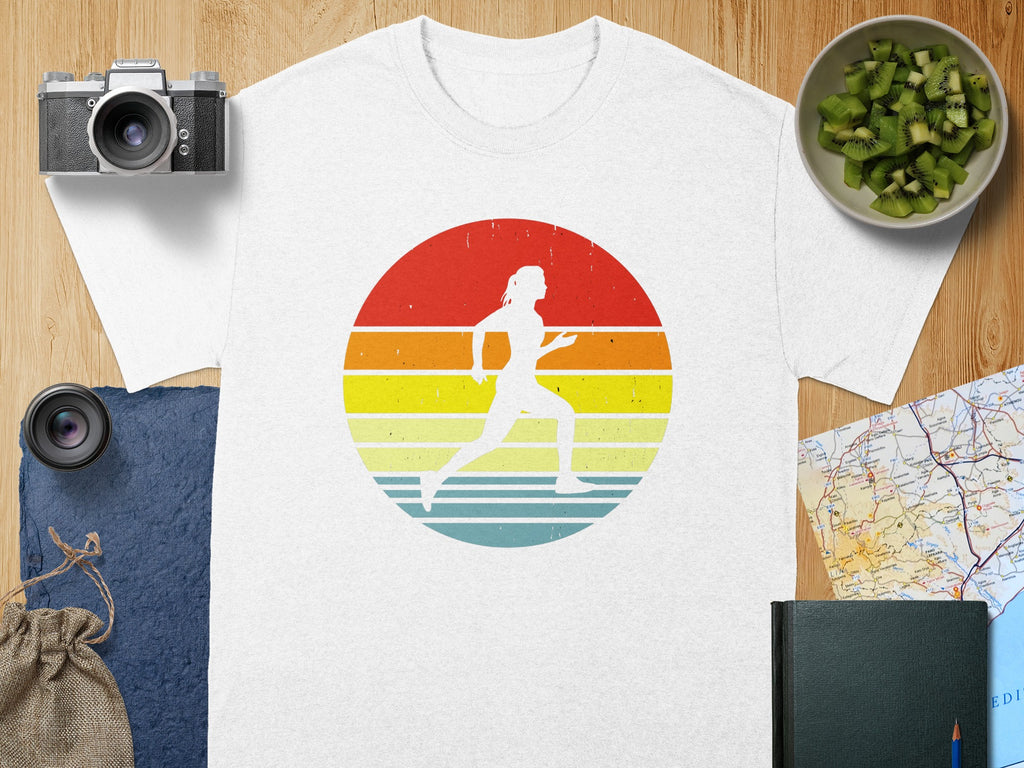 White t-shirt with a vintage runner graphic on a striped sunset background.