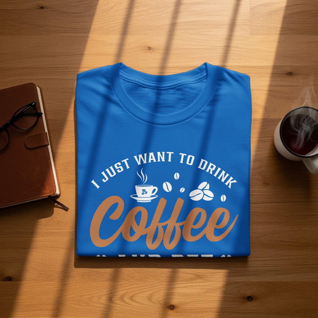 Blue t-shirt with "I just want to drink coffee" text and coffee bean graphics.