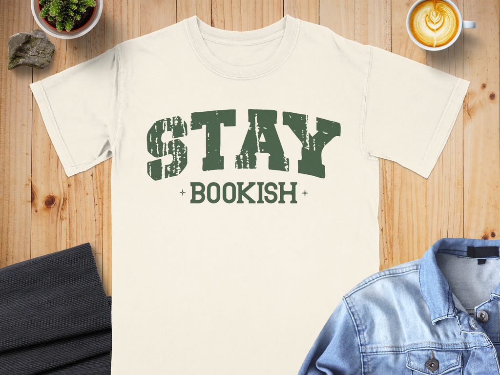 Cream t-shirt with distressed green text reading "STAY BOOKISH".