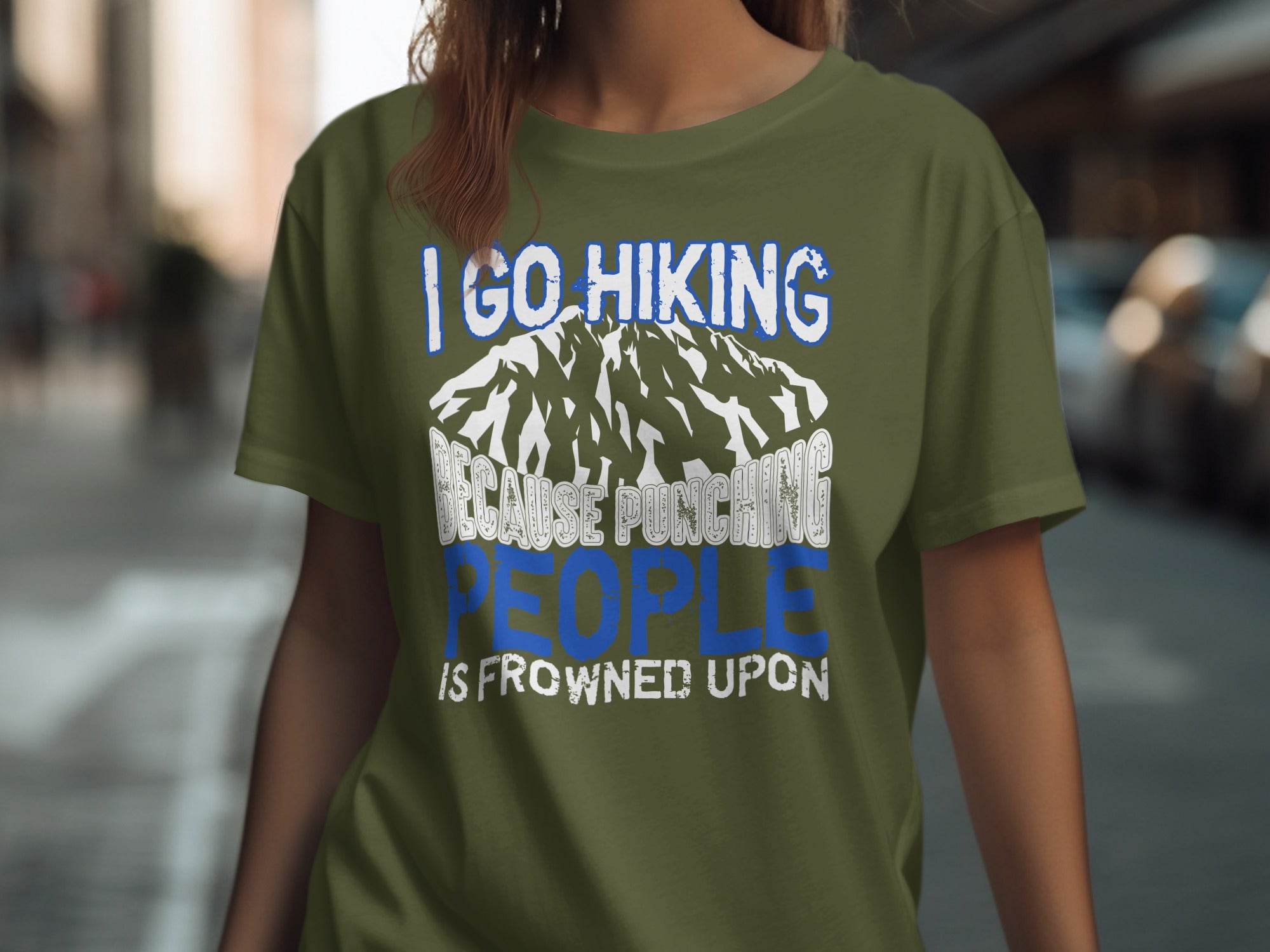 Olive t-shirt with "I go hiking because punching people is frowned upon" text and mountain graphic.