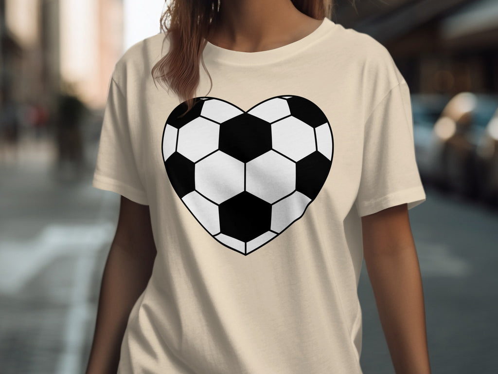 Tan t-shirt with black and white heart-shaped soccer ball graphic on chest.