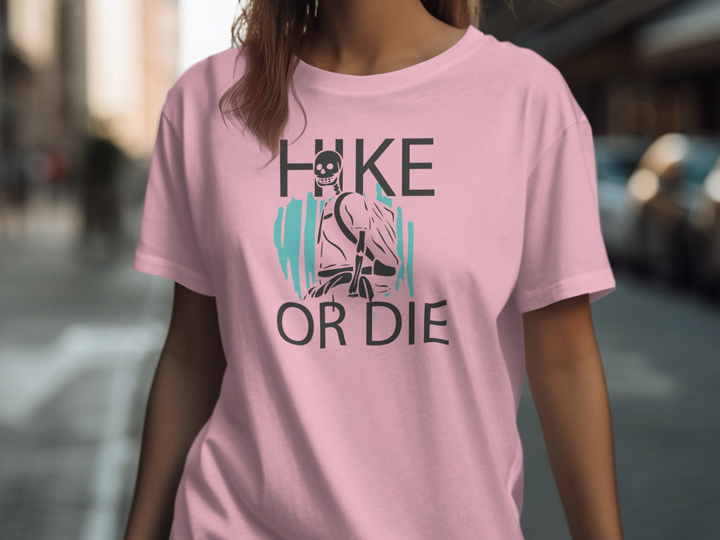 Pink t-shirt with graphic "HIKE OR DIE" and a skeleton hiker.