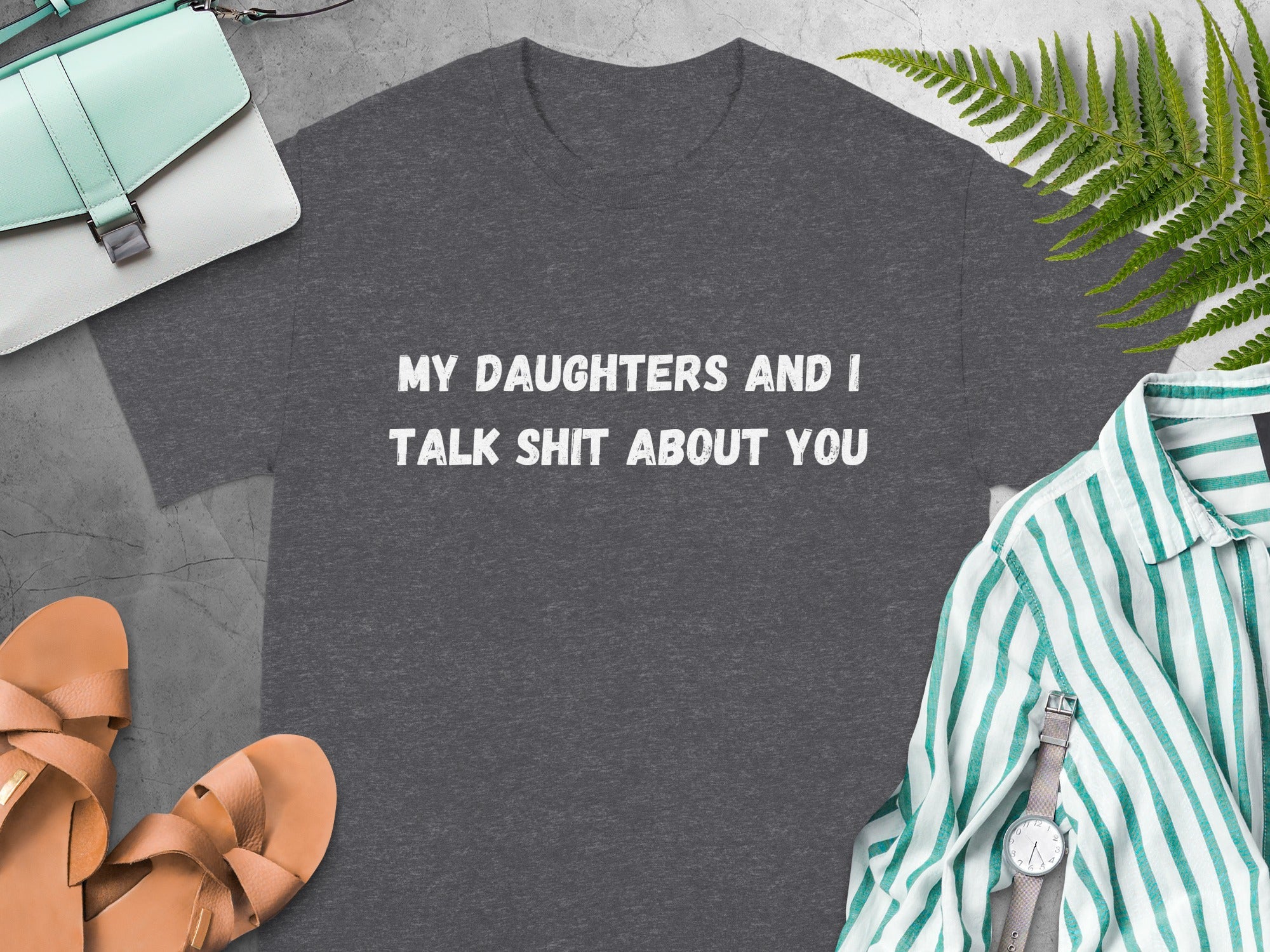 Dark gray t-shirt with white text reading "MY DAUGHTERS AND I TALK SHIT ABOUT YOU".