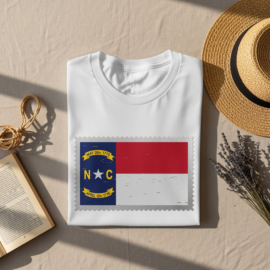 White t-shirt with North Carolina flag stamp graphic and textured border.