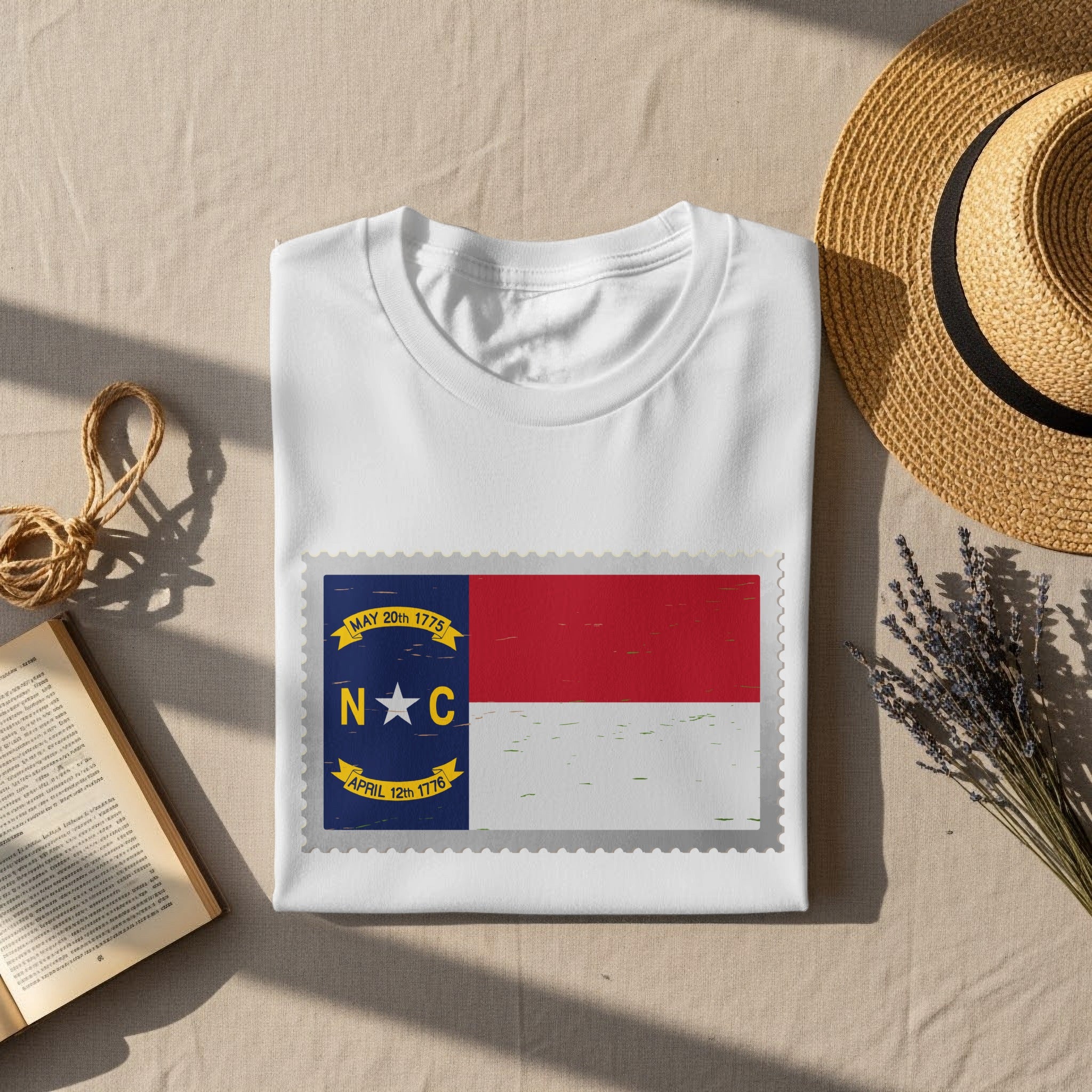 White t-shirt with North Carolina flag stamp graphic and textured border.