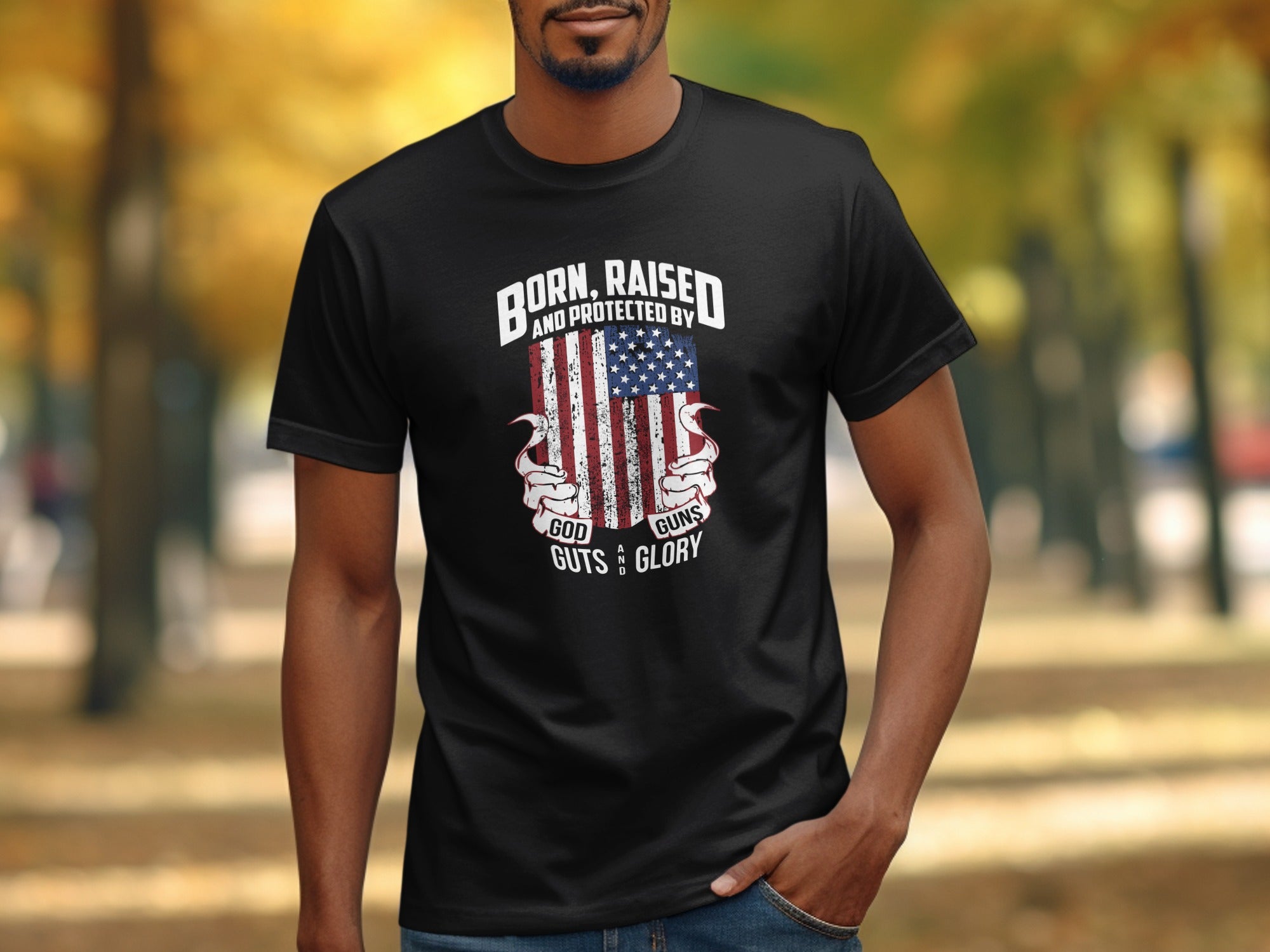 Black t-shirt with American flag graphic and text "Born, Raised and Protected by God, Guts and Glory."