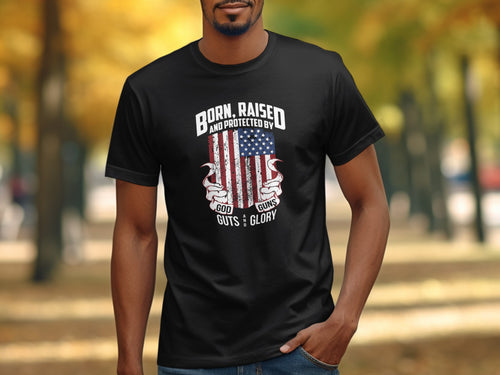 Black t-shirt with American flag graphic and text "Born, Raised and Protected by God, Guts and Glory."