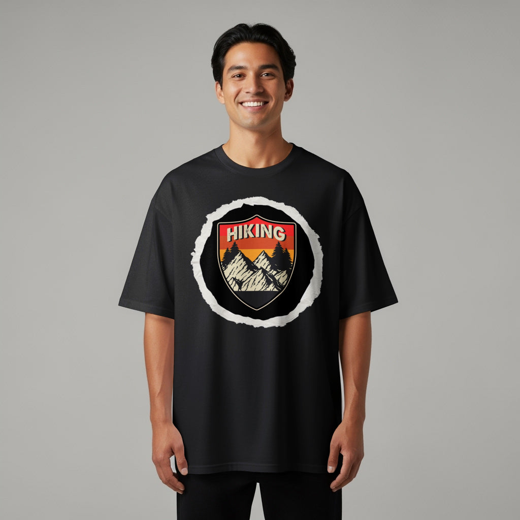 Black t-shirt with a shield logo featuring mountains, trees, and the word "HIKING".