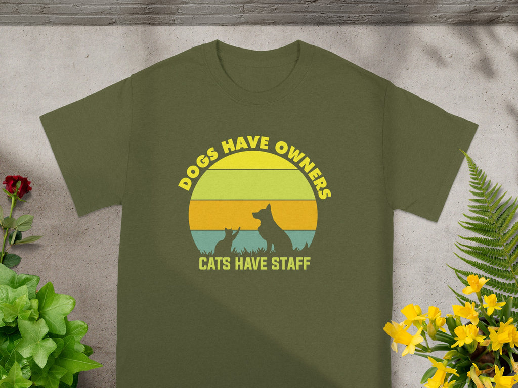 Green t-shirt with circular graphic: "DOGS HAVE OWNERS CATS HAVE STAFF".