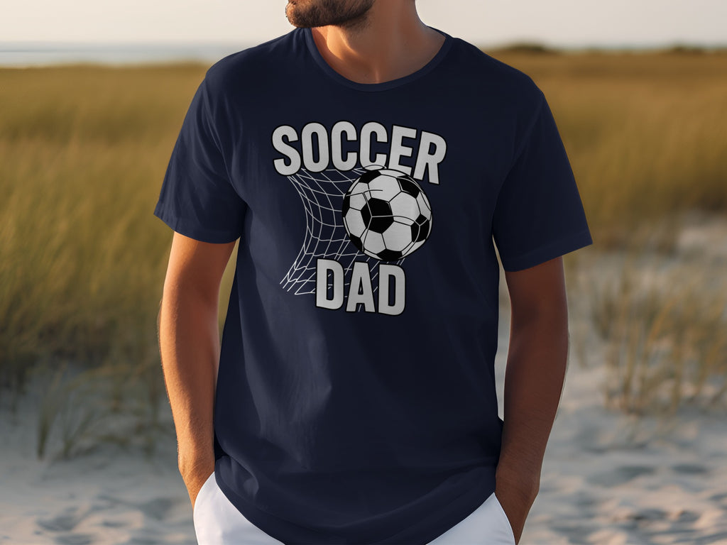Navy t-shirt with "Soccer Dad" graphic and soccer ball in net.