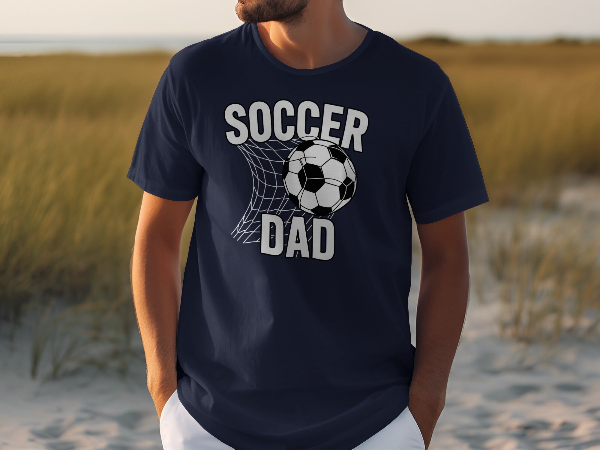 Navy t-shirt with "Soccer Dad" graphic and soccer ball in net.
